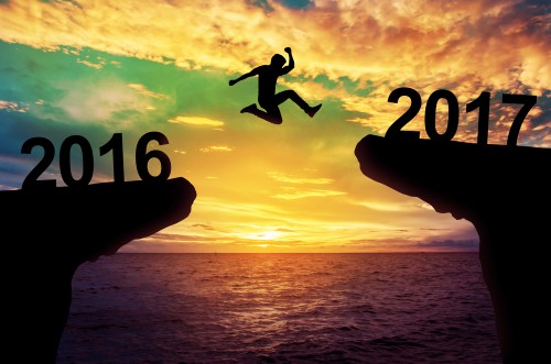 man jumping between cliffs with 2016 and 2017 over each cliff